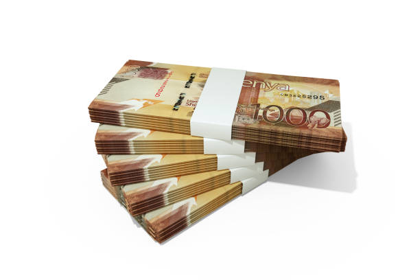 Stacks of kenya shilling notes isolated on a white background
